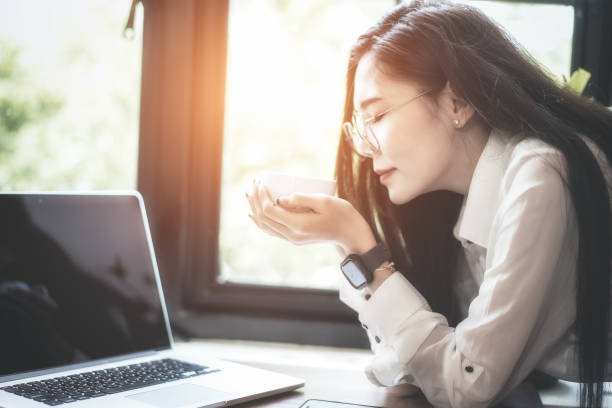 istock Woman using laptop at coffee shop. 1170242443