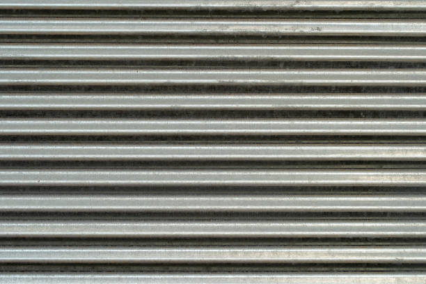 istock Metal wall texture, background. Sheet of ribbed galvanized metal for building structures. Surface has horizontal protruding ribs for stiffness 1170244615