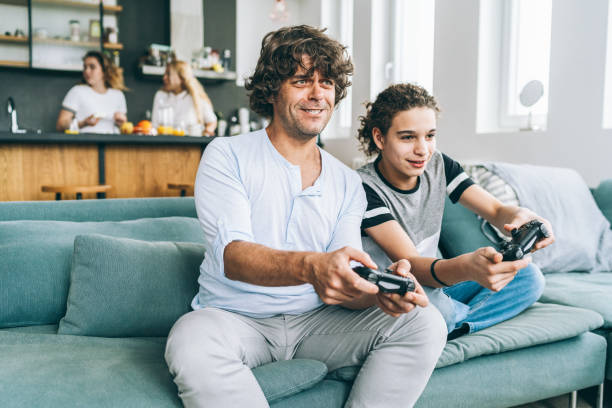 istock Father and son playing video game 1170245311