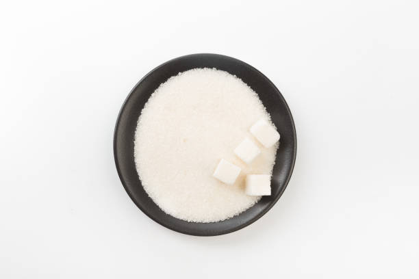 istock Bowl of sugar isolated on white background, top view 1170247354