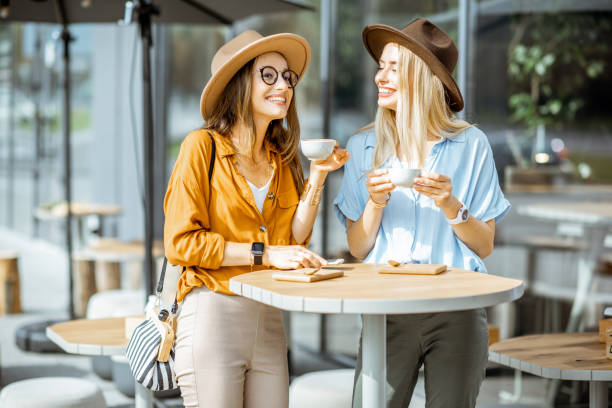 Girlfriends spending time together on a cafe terrace