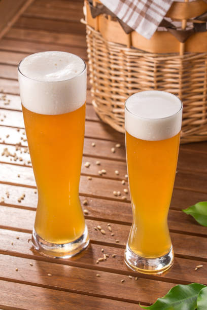 istock Two glass beer and basket on wooden table 1170249276