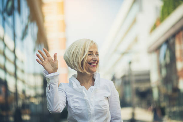 Make friends in the aisle. Senior business woman.