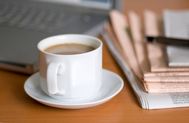 istock Coffee, laptop, newspaper and a fountain pen on table 117025196
