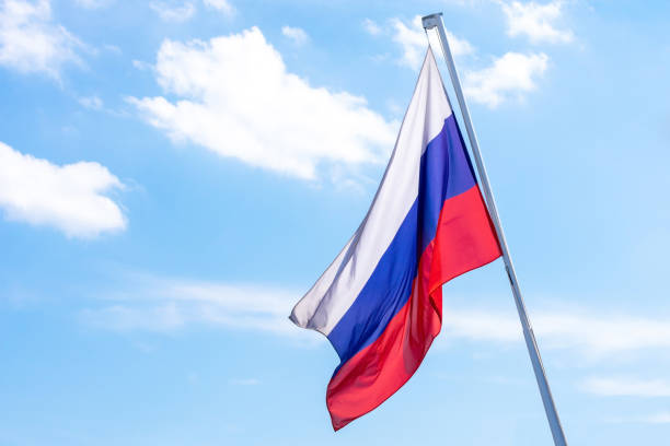 istock Russian flag on blue sky background. 1170254761