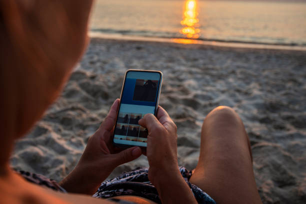 istock Woman using mobile phone on the beach 1170254789