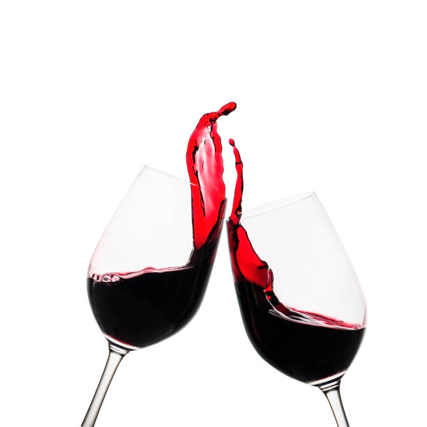 istock Two clinking glasses of red wine in a toast 1170256281