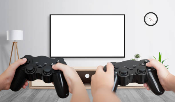 istock Two friends playing game on large TV with isolated screen for game presentation. 1170259061
