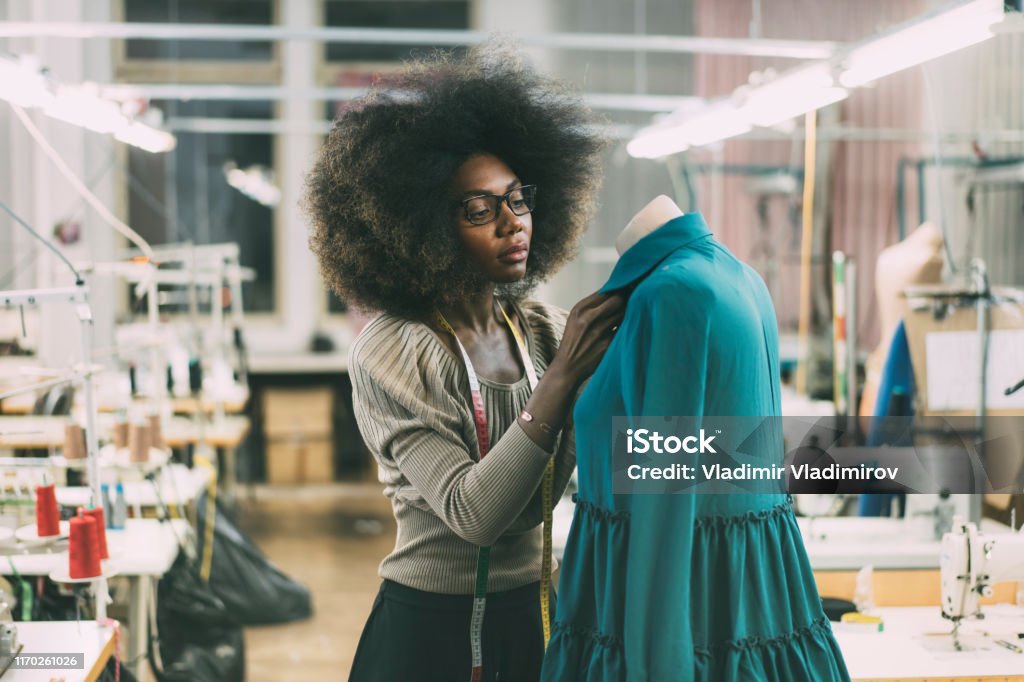Young fashion designer Young fashion designer at her workplace Fashion Designer Stock Photo