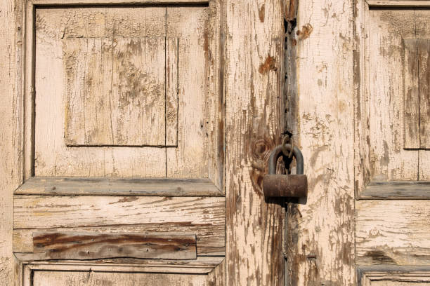 istock barn lock rusty and old hanging on old wooden doors 1170262392