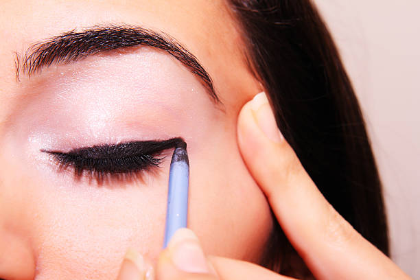 istock Young woman applying makeup 117026347