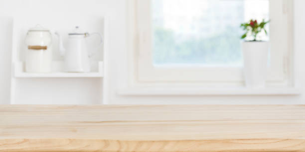 istock Kitchen table top in front of blurred window and shelves 1170263739