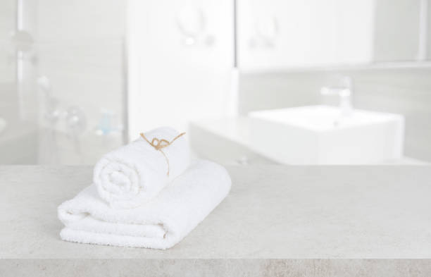 istock White towels on table in defocused bathroom with copy space 1170264929