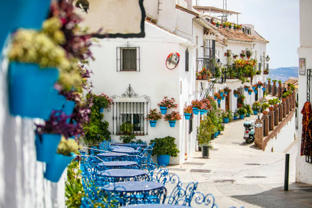 Streets of Mijas Beautiful street in Mijas with white houses decorated with colorful flower pots. costa del sol málaga province photos stock pictures, royalty-free photos & images