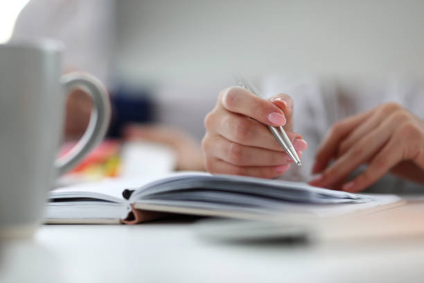 istock Arm of female executive holding silver pen 1170267190
