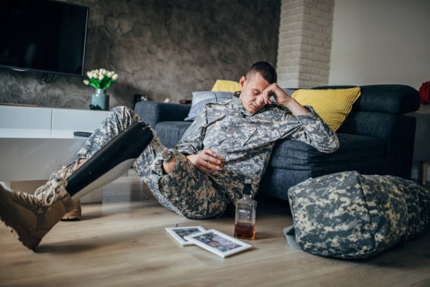 istock Sad veteran US soldier drinking alcohol alone 1170268728