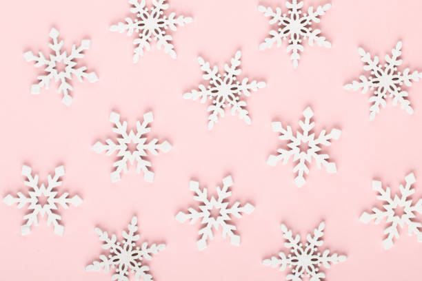 istock Christmas background. White snow decorations on a pink background. 1170271391