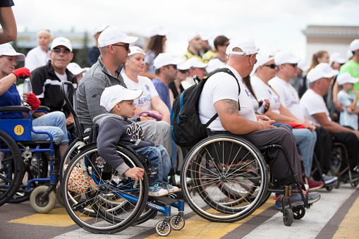 Belarus, the city of Gimel, July 03, 2019. Youth Festival. People in wheelchairs on a city street