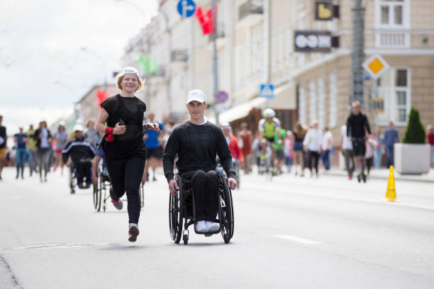 People with disabilities and healthy together run a marathon Belarus, the city of Gimel, July 03, 2019. Youth Festival.People with disabilities and healthy together run a marathon paralympic games stock pictures, royalty-free photos & images