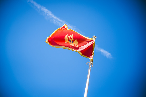 Flag of Montenegro on blue sky background
