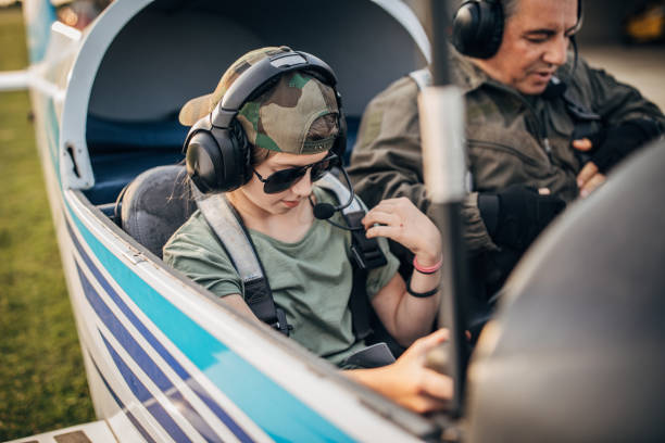 istock Pilot and his daughter sitting in cockpit 1170273913