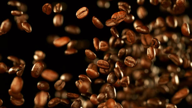istock Fresh roasted coffee beans flying in the air 1170275627
