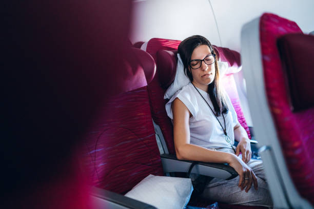 istock Female passenger sleeping in airplane 1170276795