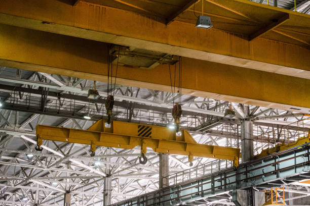 istock Yellow overhead crane. Jib crab trolley with hooks and linear traverse. 1170277061
