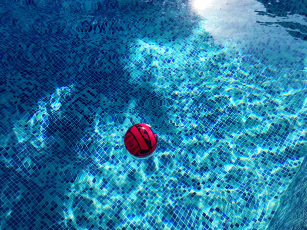 istock Pink ball floating in a blue pool 1170277764