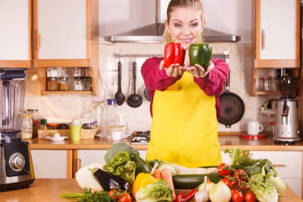 istock Woman holding two bell peppers 1170277798