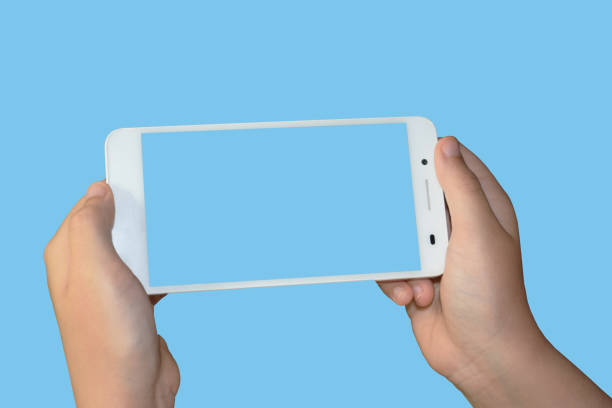 istock hands taking picture with white cellphone on a light blue background 1170277863