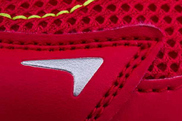 Fragment of red sneaker fabric. The texture of the material of sports shoes Fragment of red sneaker fabric. The texture of the material of sports shoes multi colored woven macro mesh stock pictures, royalty-free photos & images