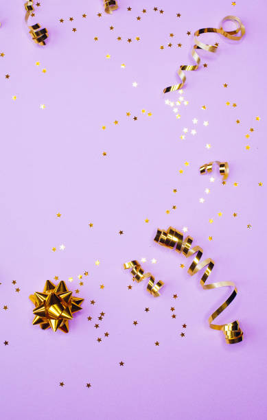 istock Golden decorations and sparkles on pale purple background 1170278420