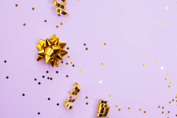 istock Golden decorations and sparkles on pale purple background 1170278432