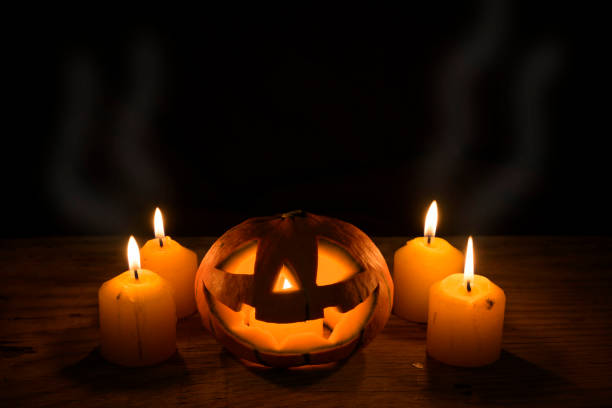 Halloween Pumpkin with candles lights on wooden background