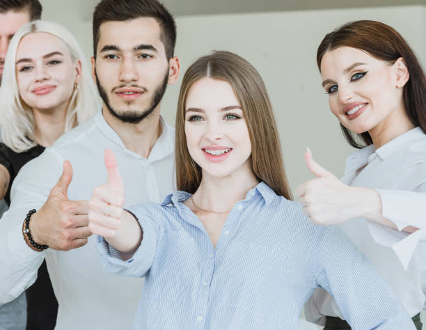 istock Cheerful young business group giving thumbs up 1170280297