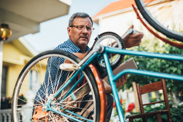 istock Mature man fixing bike 1170280377
