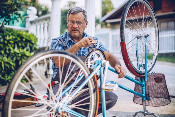 istock Senior man repairing bicycle 1170280617