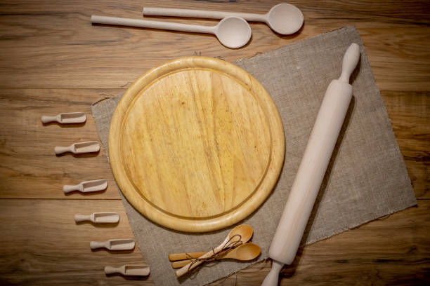 istock Wooden kitchen accessories: plate, rolling pin, board, spatula on a concrete background. Top view. Kitchenware. 1170281880