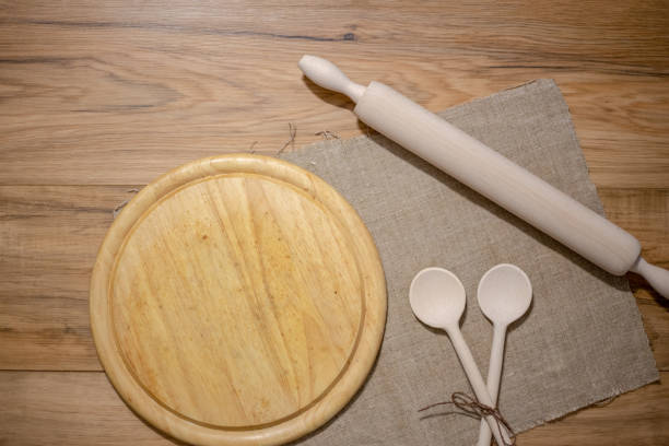 istock Wooden kitchen accessories: plate, rolling pin, board, spatula on a concrete background. Top view. Kitchenware. 1170282790