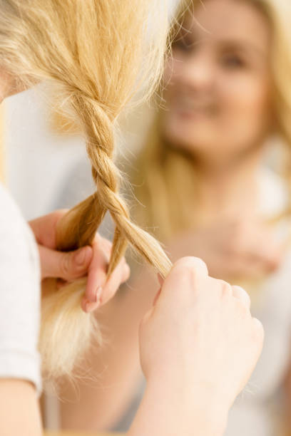 istock Woman making braid on blonde hair 1170282870