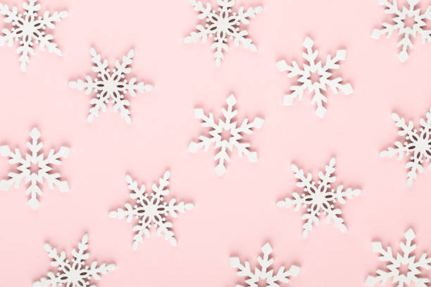 istock Christmas background. White snow decorations on a pink background. 1170283183