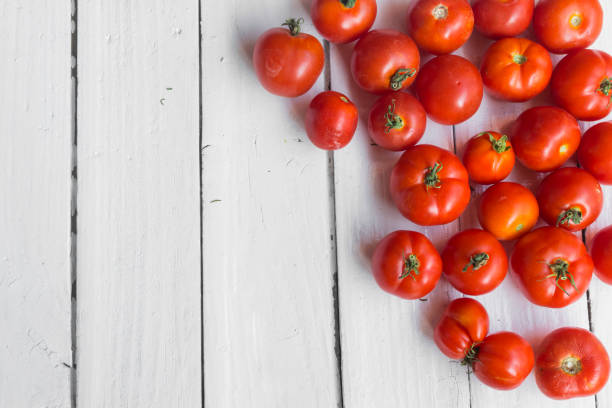 istock Cherry tomatoes on old white background with place for text 1170284507