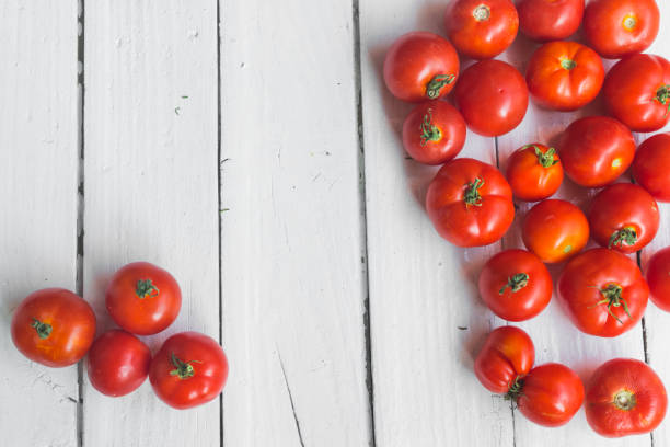 istock Cherry tomatoes on old white background with place for text 1170284528