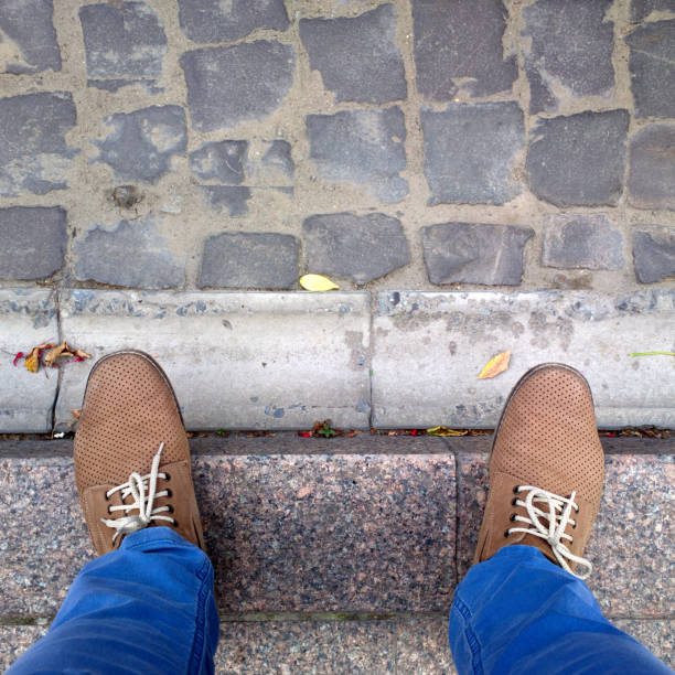 istock Feet near the drain outside. 1170286179