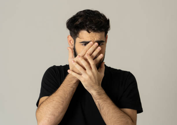 istock Young man feeling scared and shocked making fear anxiety gestures. Looking terrified and desperate trying to cover himself. Portrait with copy space. People and Human expressions and emotions. 1170286350