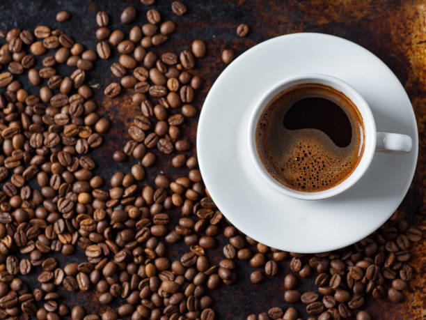 istock White espresso coffee Cup on vintage rusty background with scattered roasted coffee beans 1170288039