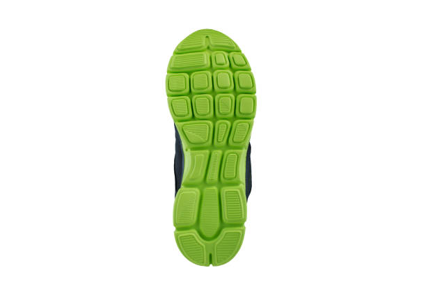 istock Green rubber sole with sneakers on a white background. 1170288223