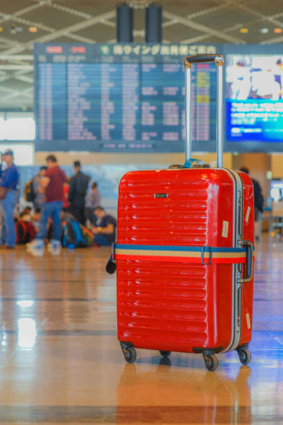 istock Red suitcase, which was placed at the airport 1170291605