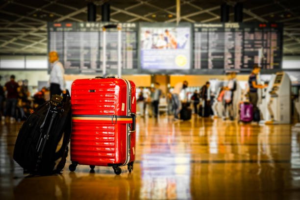 istock Red suitcase, which was placed at the airport 1170291612